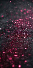 Abstract close-up of a dark background speckled with vibrant pink glitter