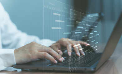 Business technology concept with hands typing on laptop and digital interface.