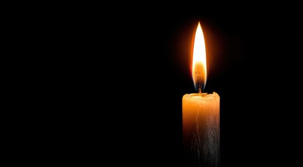 Single candle flame against black background (1)
