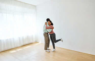 Portrait of a young couple celebrating happy moving in and relocation to a new apartment, happy young couple family new beginning