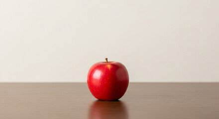 Perfectly ripe red apple gleaming on wooden surface, inviting healthy eating and fresh flavors for vibrant nutrition campaigns