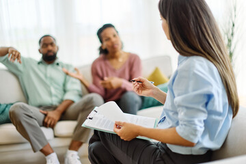 Fototapeta premium Portrait of wife and husband during marriage therapy with counselor, marriage counselor supporting conflicted couple