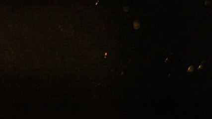 Abstract golden light overlay features dancing bokeh circles and streaking lights against a dark background, perfect for adding atmospheric, glittering texture or holiday charm. - Powered by Adobe