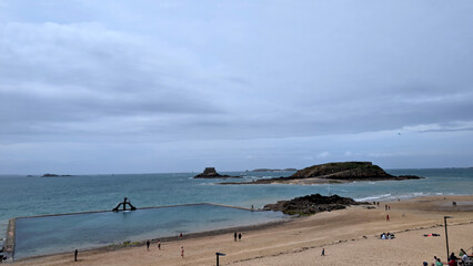 Beach and Tidal Pool with People Walking in Saint-Malo, France