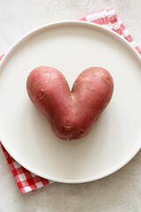 Heart shaped potato on white plate