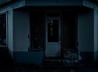 Dark and moody photograph of an abandoned closed storefront with peeling paint, broken facade, and empty display windows.