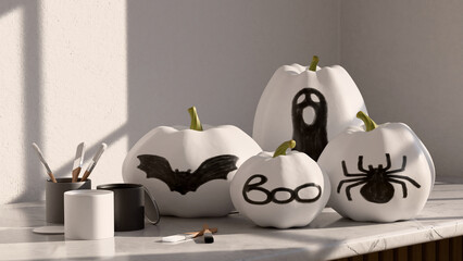 Black and white pumpkins decorated with silhouettes of spider, bat, ghost and boo word. Cans of paint and brushes are nearby, showcasing a DIY autumn craft scene.