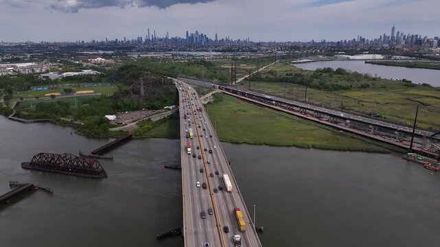 Interstate highway 95 with traffic driving over Hackensack River in New Jersey. New York City skyline seen on the horizon