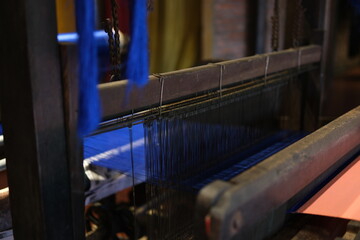 Cinematic video of silkworms hatching, feeding on mulberry leaves, spinning cocoons, and silk...