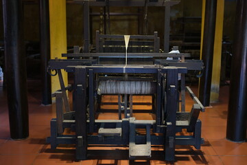 Cinematic video of silkworms hatching, feeding on mulberry leaves, spinning cocoons, and silk threads being reeled and woven into traditional Vietnamese textiles.