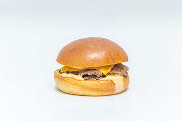 Gourmet burger with a blend of  beef sirloin, melted   cheese, red cherry tomato, and iceberg lettuce on brioche bread with herbs