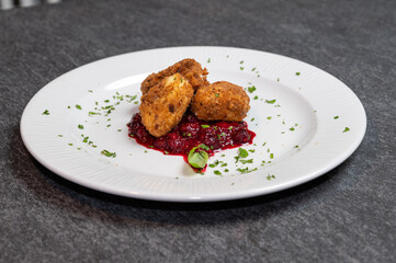 Crispy Fried Camembert Cheese with Sweet Cranberry Sauce on White Plate. Gourmet Appetizer Dish