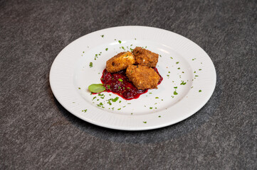 Crispy Fried Camembert Cheese with Sweet Cranberry Sauce on White Plate. Gourmet Appetizer Dish