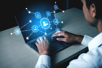 A person types on a laptop in a modern workspace, surrounded by digital connection icons, symbolizing technology, communication, and data exchange in today world. Tessel
