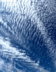 Panoramic pattern of white clouds up in a blue sky