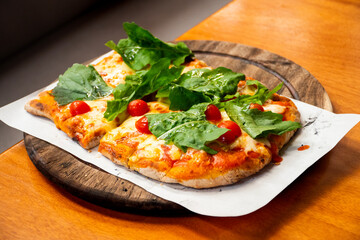 margherita pinsa pizza with basil and cherry tomatoes angled