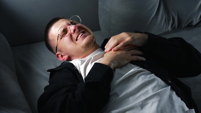 A young man with severe chest pain during a heart attack.
Heart pain due to high blood pressure, strain, and stress.
Sharp heart pain.
Chest, heart, arrhythmia, panic