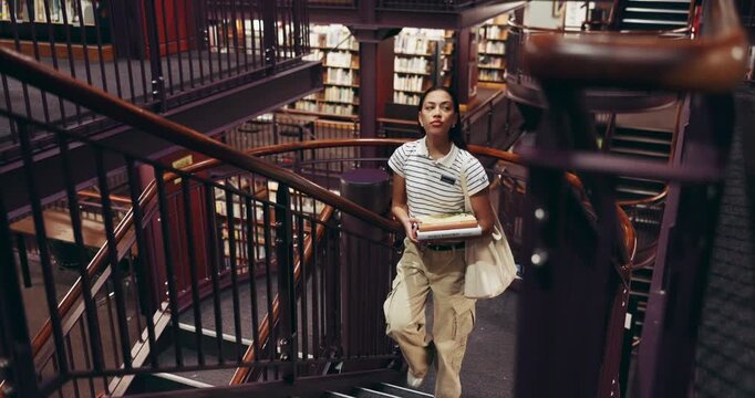 Woman, student and steps with books in library for learning, study resources and assignment research. Female person, walking and stairs with textbook, education material and knowledge of college exam