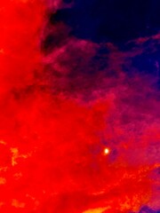Red Clouds and White Moon: A Celestial Contrast