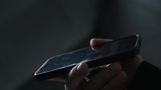 A man holding a smashed smartphone.
A dirty phone with numerous germs and infections on it.
Dirt and unsanitary conditions.
Traces of use on the mobile phone screen.