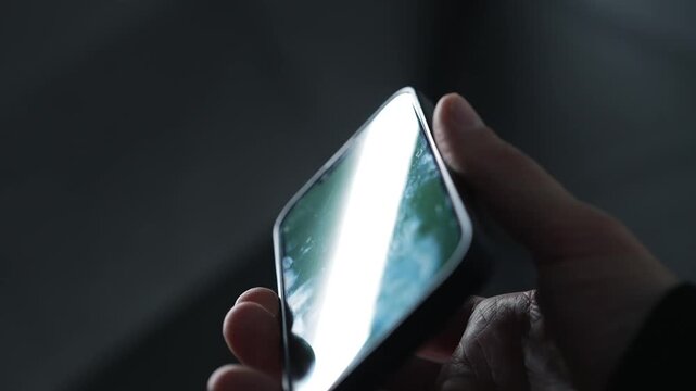 A man holding a smashed smartphone.
A dirty phone with numerous germs and infections on it.
Dirt and unsanitary conditions.
Traces of use on the mobile phone screen.