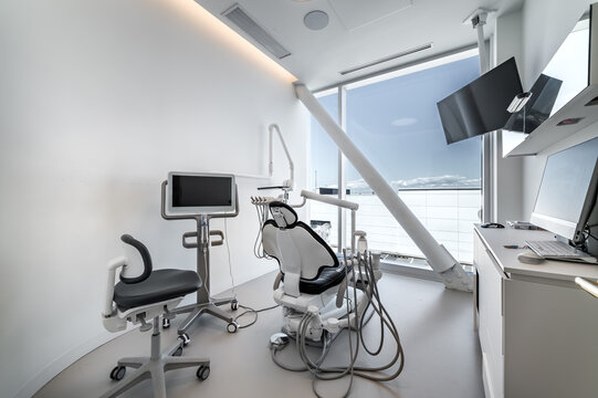 Modern dental office interior with reception desk, patient chairs, treatment rooms and professional equipment. Bright clean environment designed for healthcare and dentistry services, including x-ray 
