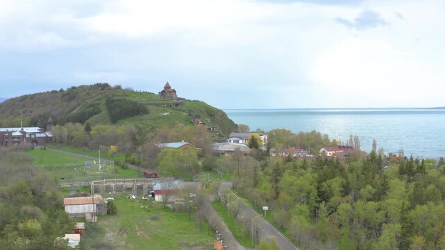 Panoramic video of Sevanavank Monastery and Lake Sevan under a cloudy sky.