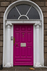 Colorful pink doors and the doorstep, the symbol of the city,  in the center of Dublin in Respublic Ireland