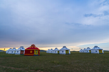 The yurt is under the blue sky and white clouds, yurts in the beautiful grassland