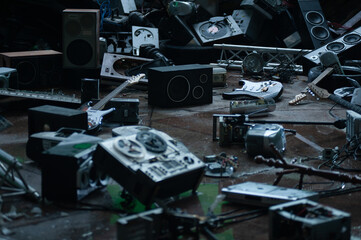 Dark blurred abstract musical techno background with vintage broken discarded musical instruments...