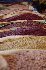 Bulk seeds and grains in sacks at market.