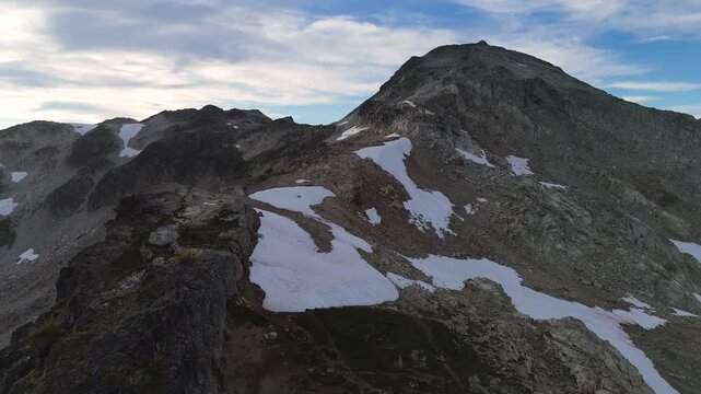 Majestic Rocky Mountain Landscape with Snow Patches Under a Blue Sky in British Columbia, Canada