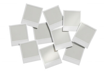 White instant photo frames scattered isolated on a transparent background
