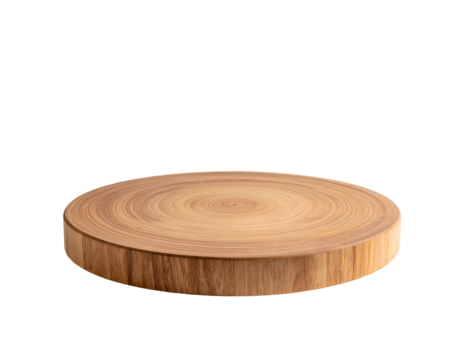 A round, wooden cutting board is isolated against a stark black background
