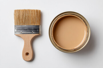 Paintbrush and open can of beige paint isolated on white background