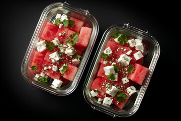 Two glass containers filled with fresh watermelon and feta salad