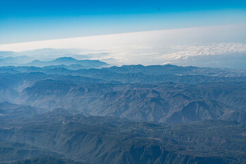 Fototapeta premium Aerial View of Rugged Desert Mountain Range with Dramatic Peaks and Valleys