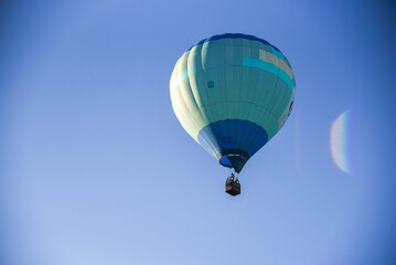 Balloons taking off into the blue sky