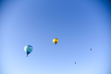Balloons taking off into the blue sky