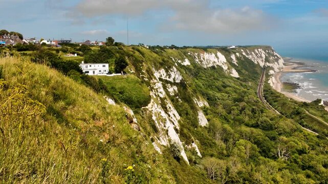 Rugged coast and railway line, Folkestone, Kent, England, UK, with chalk cliffs, sea views and tracks curving along the shoreline