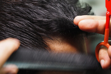 Hair stylist cutting hair in a salon setting