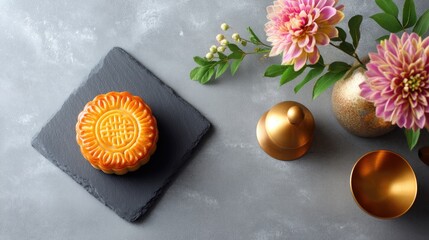Traditional Mooncake on Slate Plate with Floral Arrangement and Decorative Elements for Festive Celebrations