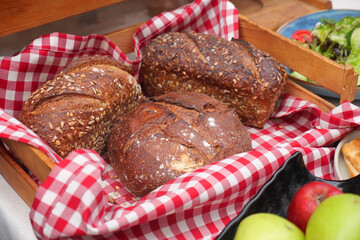 Freshly baked breads on a checkered tablecloth