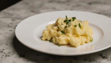 Creamy Mashed Potatoes with Chives on a White Plate.