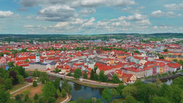 aerial panoramic view showcasing the charming medieval town of P&iacute;sek in the Southern Bohemia region of the Czech Republic. The footage highlights the iconic P&iacute;sek Stone Bridge, the oldest preserved ea