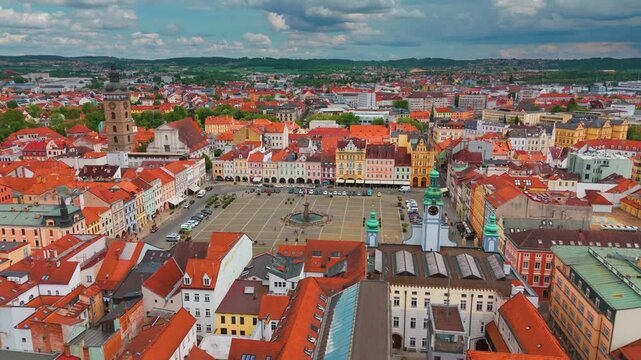 aerial perspective showcasing the vibrant, historic city center of Česk&eacute; Budějovice, Czech Republic, featuring its iconic main square, colorful baroque buildings, and the majestic Samson's Fountain, a