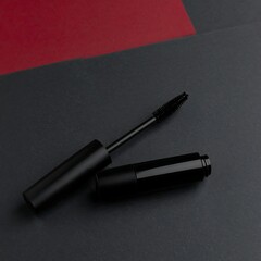 Sleek black mascara on a red and black background