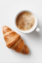 Flat lay of latte coffee and fresh croissant on white background