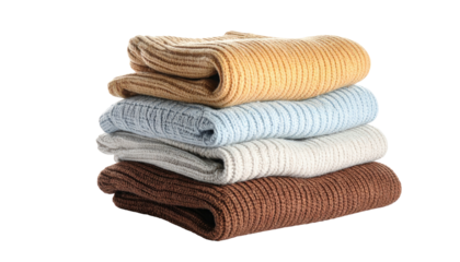 Stack of folded knit sweaters in various pastel and earth tones