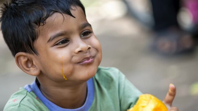 Joyful Indian child eating fresh mango, representing simple happiness in daily life